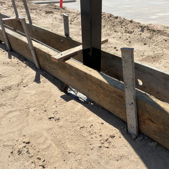 flat steel stakes stabilizing concrete forms