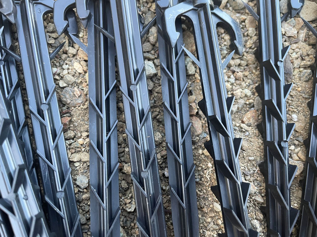 plastic landscape anchoring stakes ribbed and barbed for secure in ground installation
