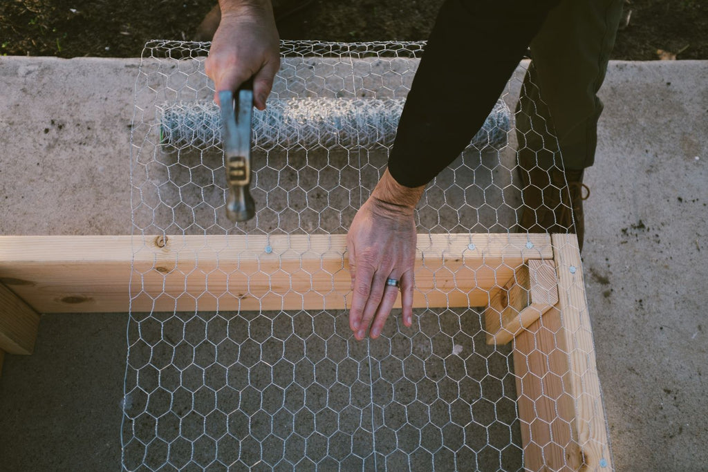 install landscape timber nails into wood garden bed