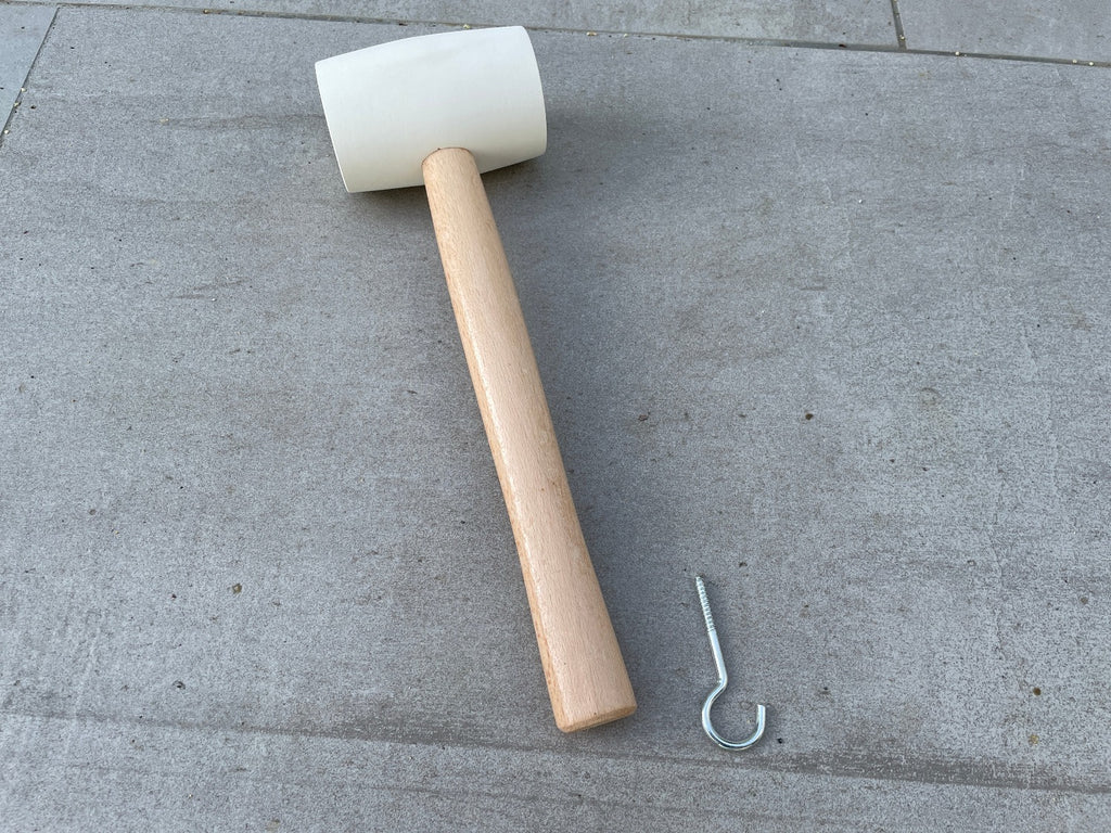 white rubber mallet tent peg remover for removing landscape staples and landscape netting.